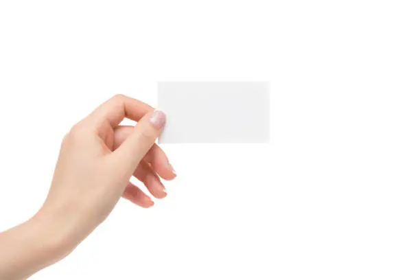 Female hand holds white card on a white background.