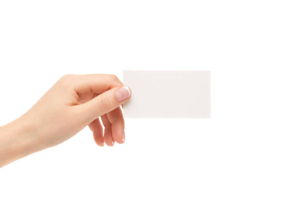 istock Female hand holds white card on a white background. 864433756