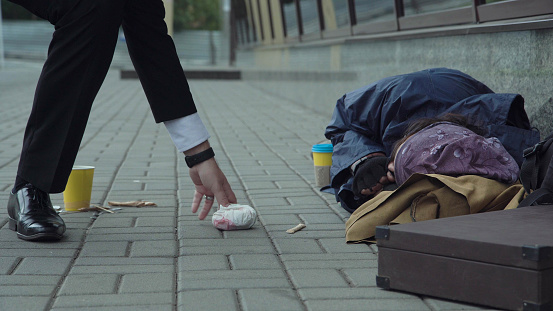 Passerby giving food to homeless