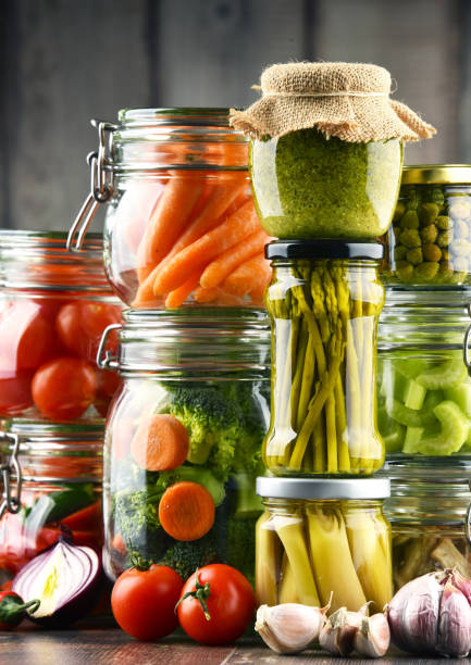 istock Jars with marinated food and organic raw vegetables 864437050