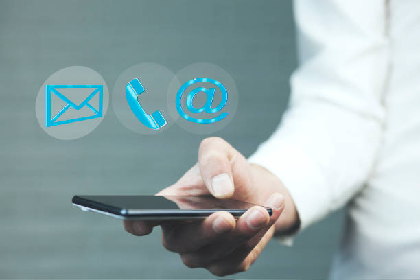 istock Man using a mobile phone while emitting a clouds of contact icons in a conceptual image. 864437900
