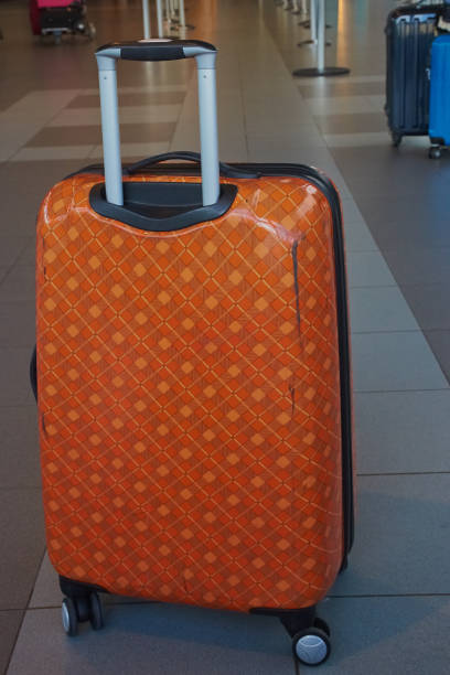 istock orange suitcase at the airport 864442152