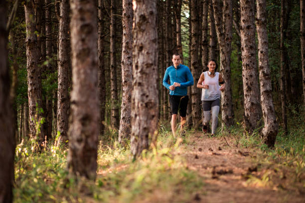 istock Couple Running In Nature 864442896