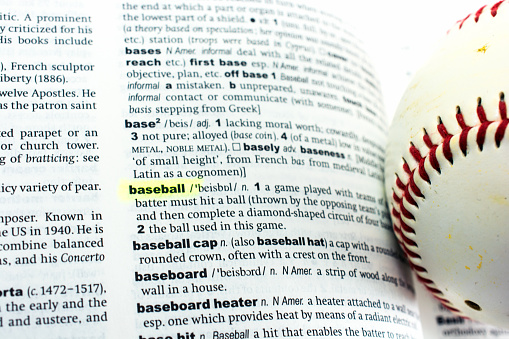 baseball laying on its definition in a dictionary