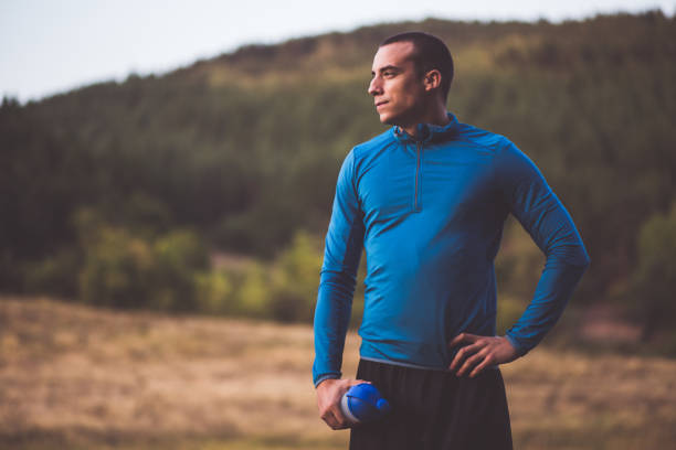 istock Confident Young Sportsman Posing In Natural Scenery 864447458