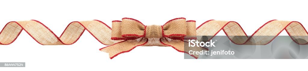 Christmas border with burlap ribbon with red trim isolated Long Christmas border with burlap bow and ribbon with red trim isolated on a white background Christmas Stock Photo