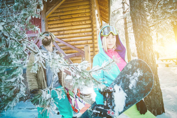 istock Two snowboarders preparing snowboards for trace 864449076