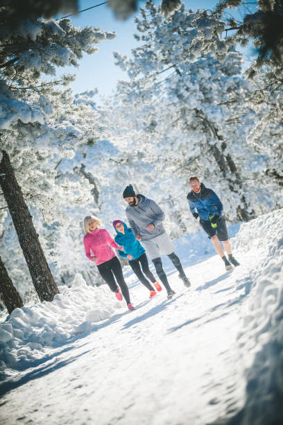 istock Friends running on snowy mountain 864449094