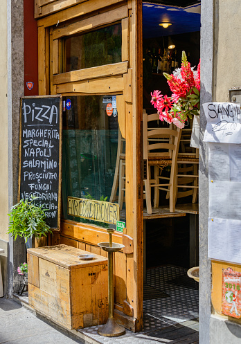 Typical street scene with the facade of an Italian pizzeria in the old town section of Florence, Italy.