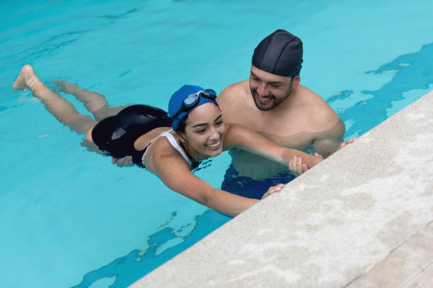 istock Woman taking swimming lessons with a teacher 864453742