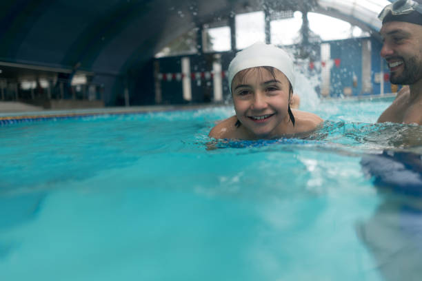 istock Boy at the pool in a swimming class 864453778