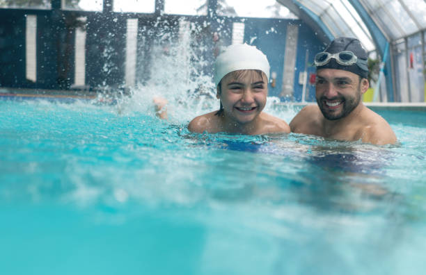 istock Happy boy taking swimming lessons 864453816