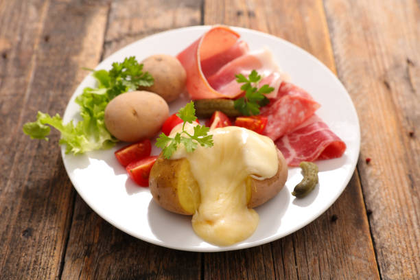 istock raclette cheese melted with potato and salami 864457514