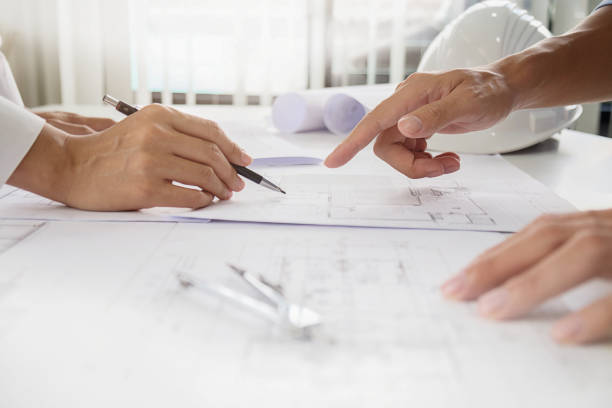 istock Hands of Engineer working on blueprint,Construction concept. Engineering tools.Vintage tone retro filter effect,soft focus(selective focus) 864458704