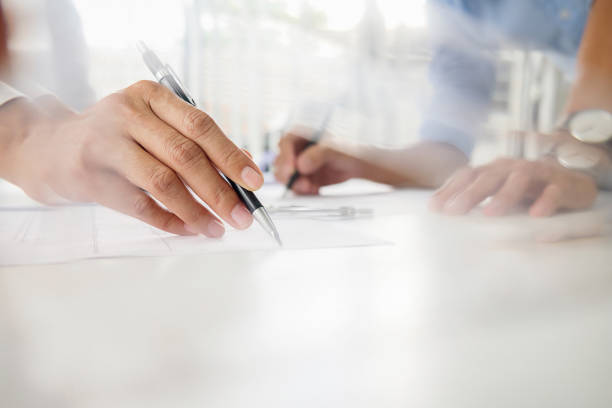 istock Hands of Engineer Working on Blueprint. Construction Concept. Engineering Tools.Vintage Tone Retro Filter Effect. Soft Focus(selective focus) 864458950