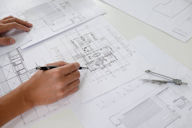 istock Hands of Engineer Working on Blueprint. Construction Concept. Engineering Tools.Vintage Tone Retro Filter Effect. Soft Focus(selective focus) 864458982