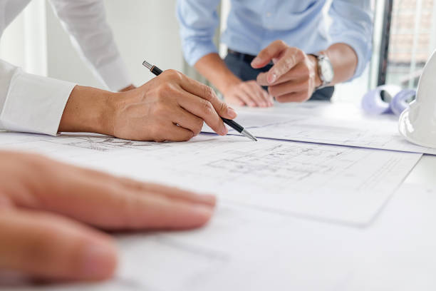 istock Hands of Engineer Working on Blueprint. Construction Concept. Engineering Tools.Vintage Tone Retro Filter Effect. Soft Focus(selective focus) 864458986