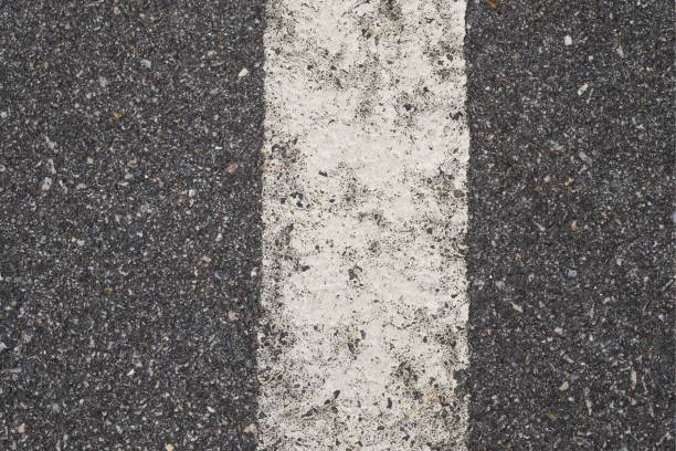 istock ASPHALT TEXTURE WITH WHITE SEPARATION LINE / TOP VIEW / FOR BACKGROUND 864462272
