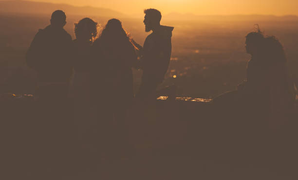 Granada, Spain - September 17th, 2017: A Group of friends enjoying the sunset from St.Miguel Point above Granada, Spain