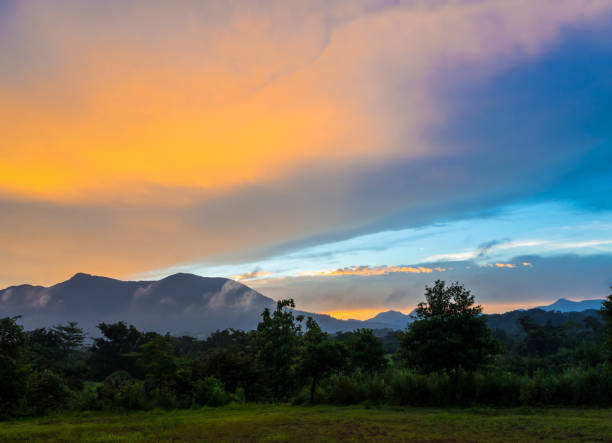 istock Colorful Sky and Clouds drifting over the forest mountain in evening time 864463490