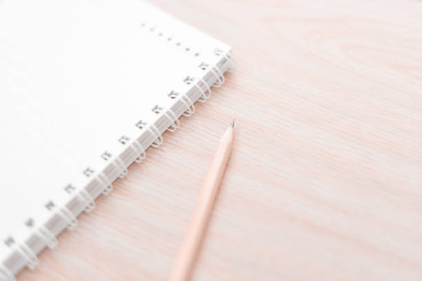 istock Blur pencil and notebook diary concept in white tone. 864463718