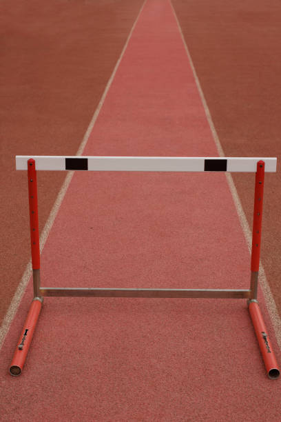 istock The first obstacle. Concept with one hurdle on red track. 864465864