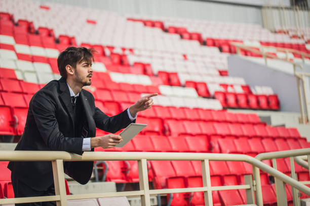 istock Coach standing on the bleachers 864467066
