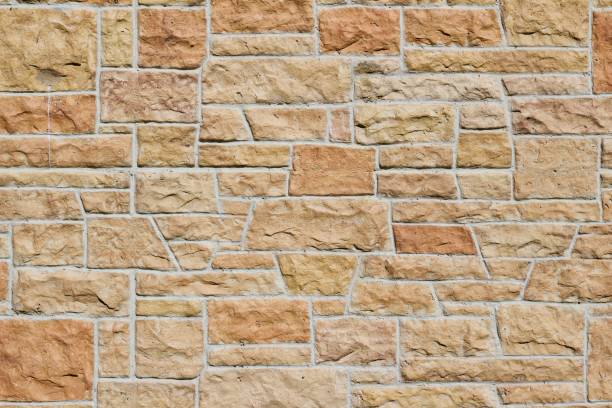 istock Pink and Orange Hue Aged Limestone Brick Wall Background 864469868