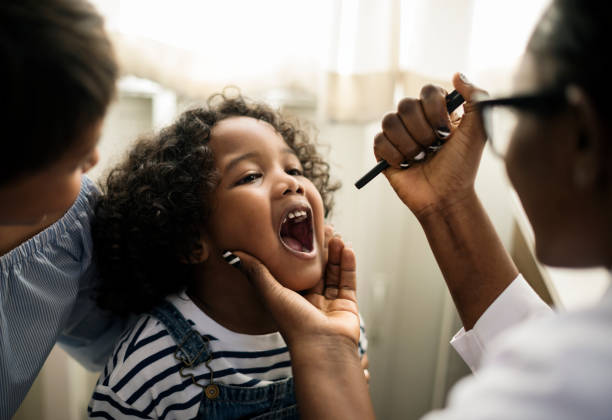 istock Little girl having her teeth checked 864469872