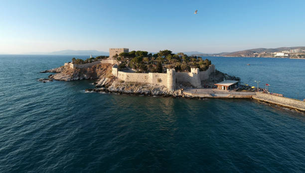 Güvercinada (Pigeon Island) is a peninsula in western Turkey connected to mainland Kuşadası, Aydın, Turkey. There is a 15th century building on the island which is free, public and no ticket requested. This island is not in Europe, it's in Asia.