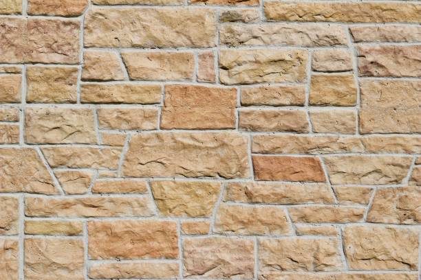 istock Pink and Orange Hue Aged Limestone Brick Wall Background 864470508
