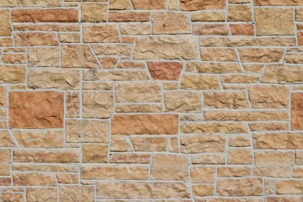 istock Pink and Orange Hue Aged Limestone Brick Wall Background 864470510