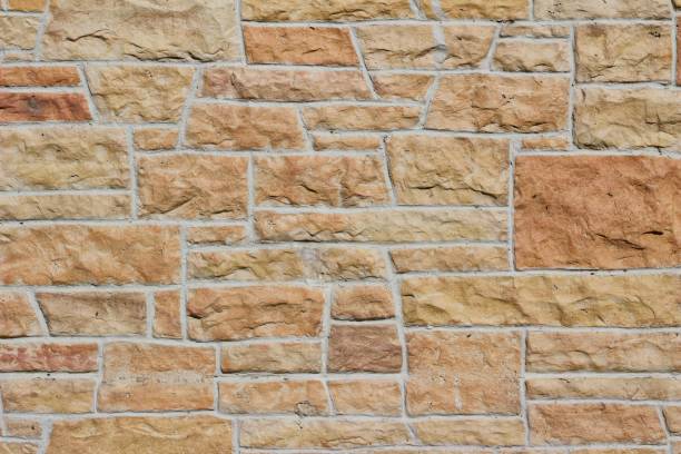 istock Pink and Orange Hue Aged Limestone Brick Wall Background 864470638