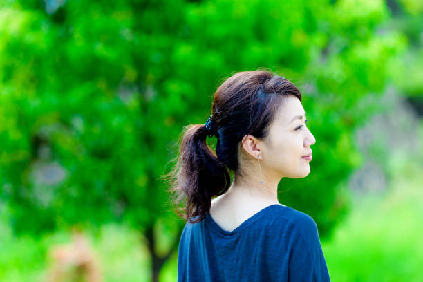 istock Green blur background and girls 864471432