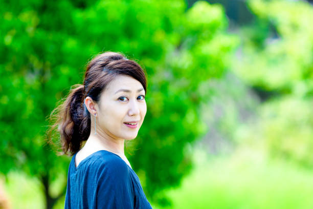 istock Green blur background and girls 864471470