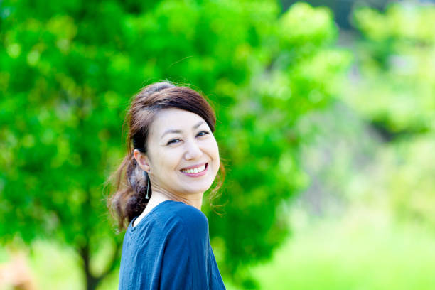 istock Green blur background and girls 864471534