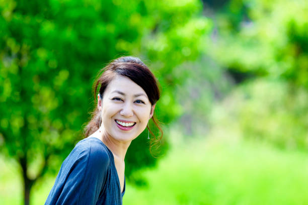 istock Green blur background and girls 864471564