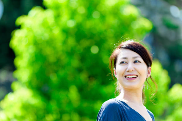 istock Green blur background and girls 864471708