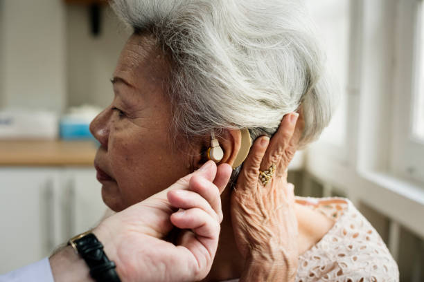 istock An elderly woman with hearing aid 864471752