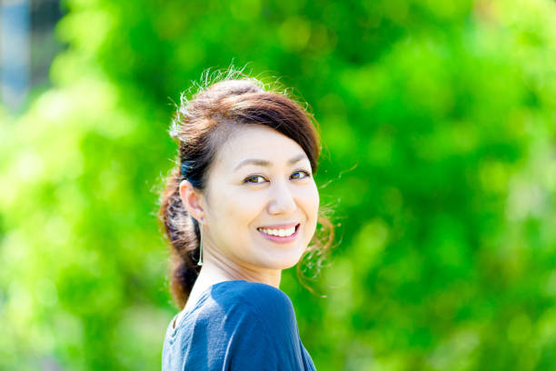 istock Green blur background and girls 864471862