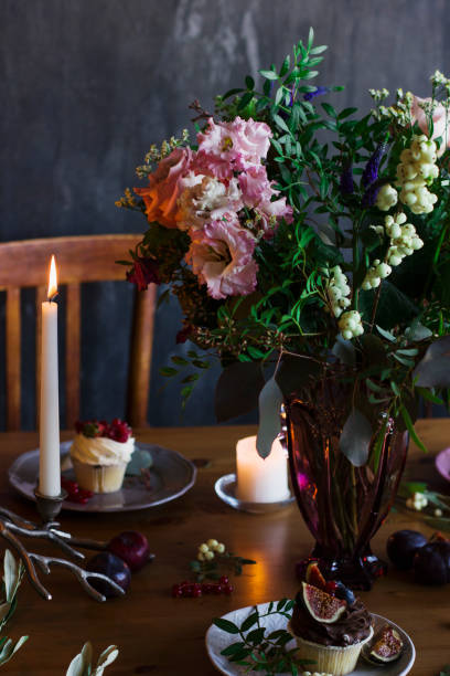 istock The beautiful festive table with rustic bouquet, dessert and candles 864473082