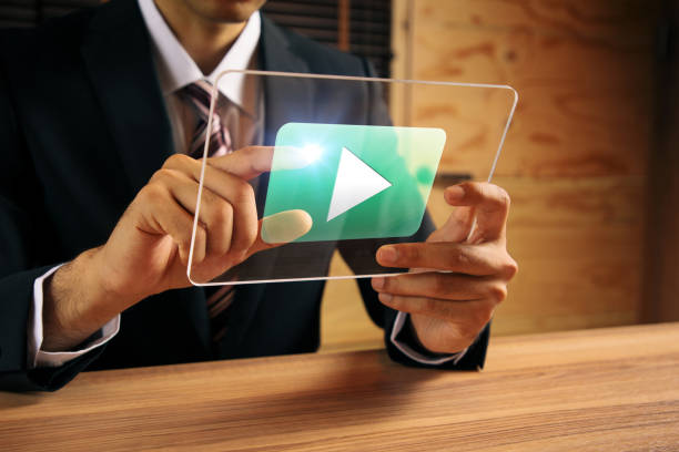 businessman watching a movie with transparent tablet.