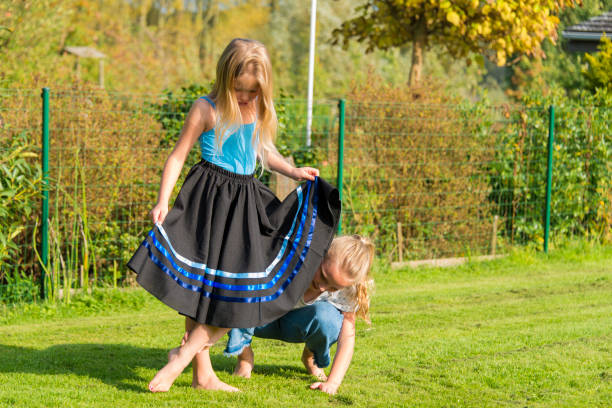 istock Blonde sisters doing ballet exercises in the garden 864475990