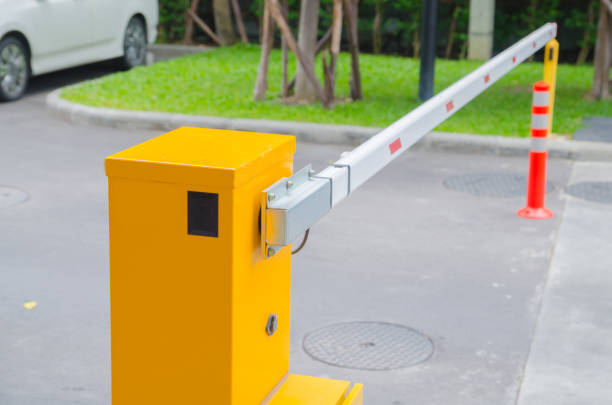 istock Security system for building access - barrier gate stop with toll booth, traffic cones and cctv 864476900