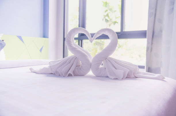 swan of white towel on bed
