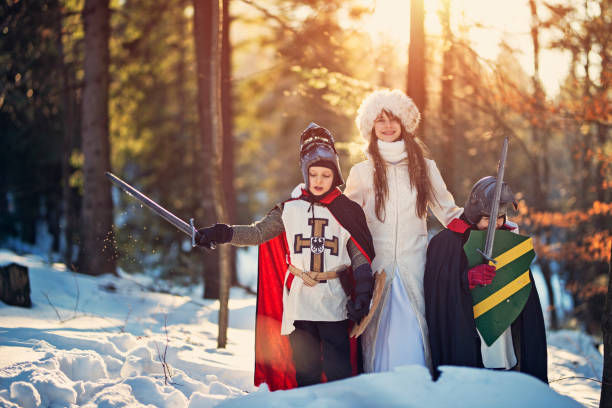 istock Children playing knights in winter forest 864477148