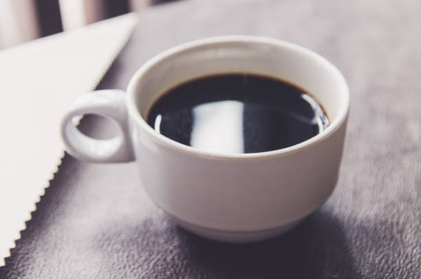 istock Coffee cup and saucer on a wooden table . 864478366