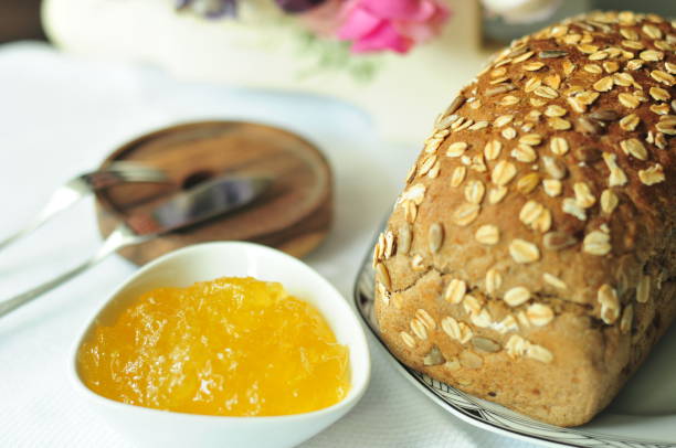 Fruit Loaf or bread with raisins also known as Bara Brith and milk or orang juice on wood