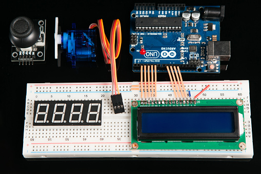 Kharkov, Ukraine - March 21, 2017: Arduino UNO board with electronic components, top view. Microcontroller for programming and prototyping with breadboard