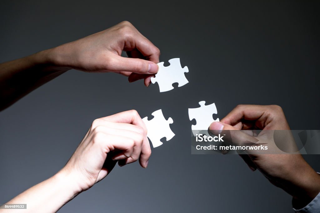 hands holding jigsaw puzzles, business to business, business matching concept Three Objects Stock Photo